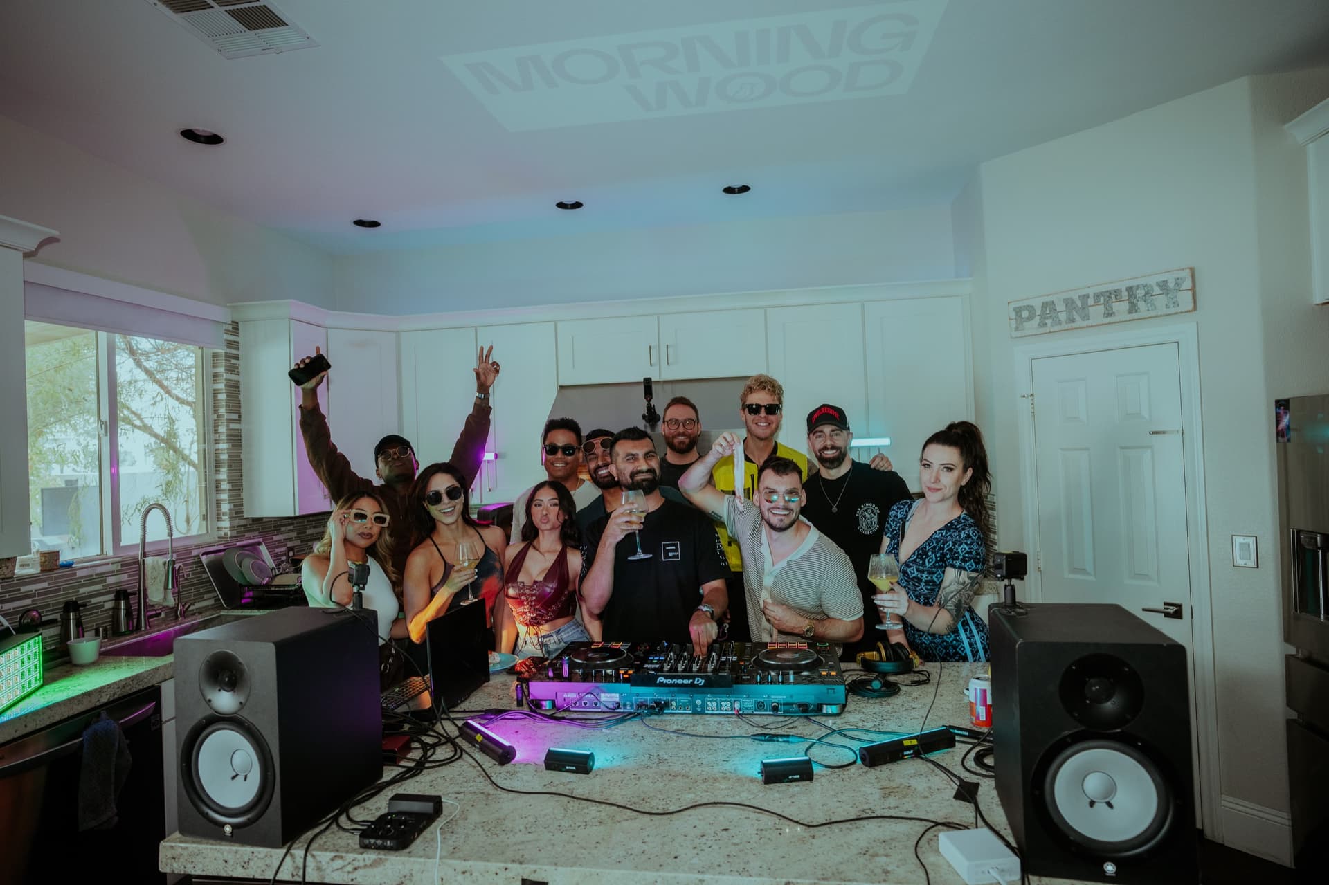 Morning Wood Kitchen's first event — friends gathered around a kitchen island with DJ decks, March 2025